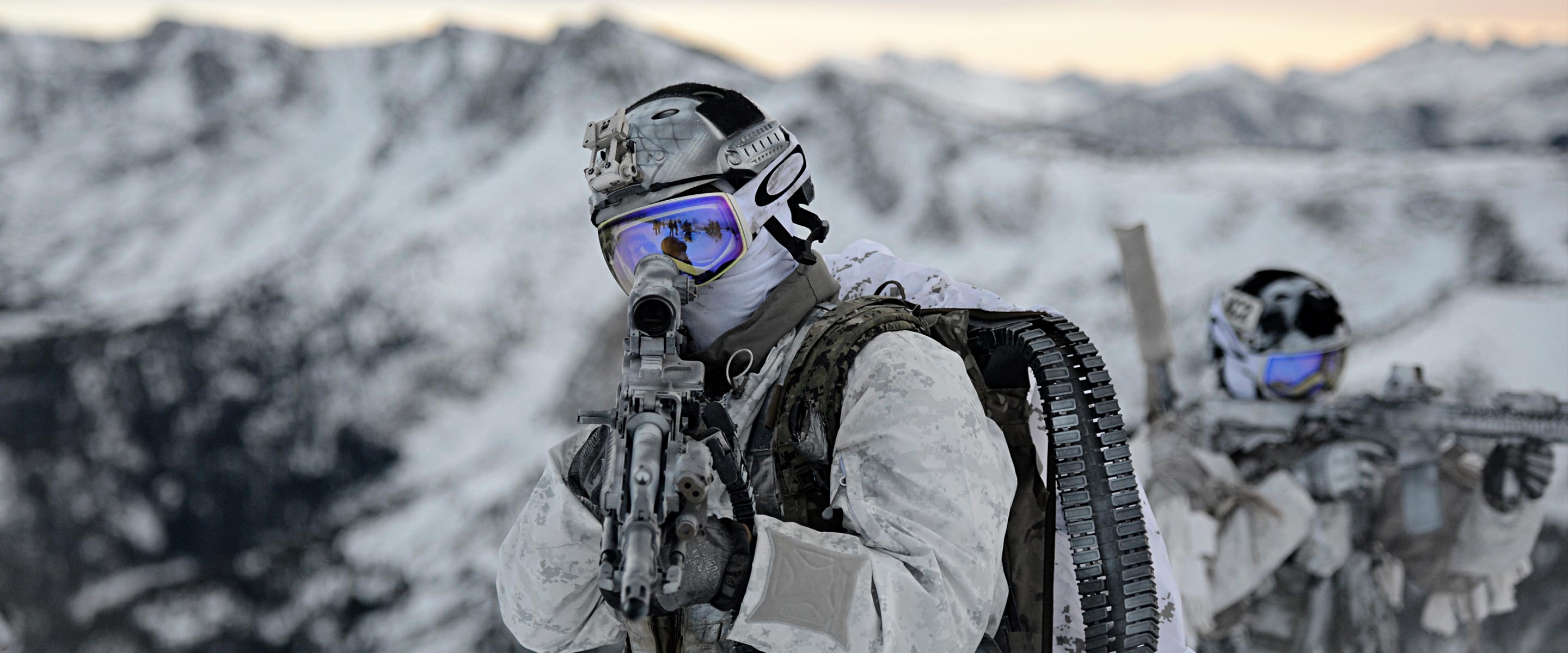 A team of United States Navy Seals in full gear works together during a spec ops training session.