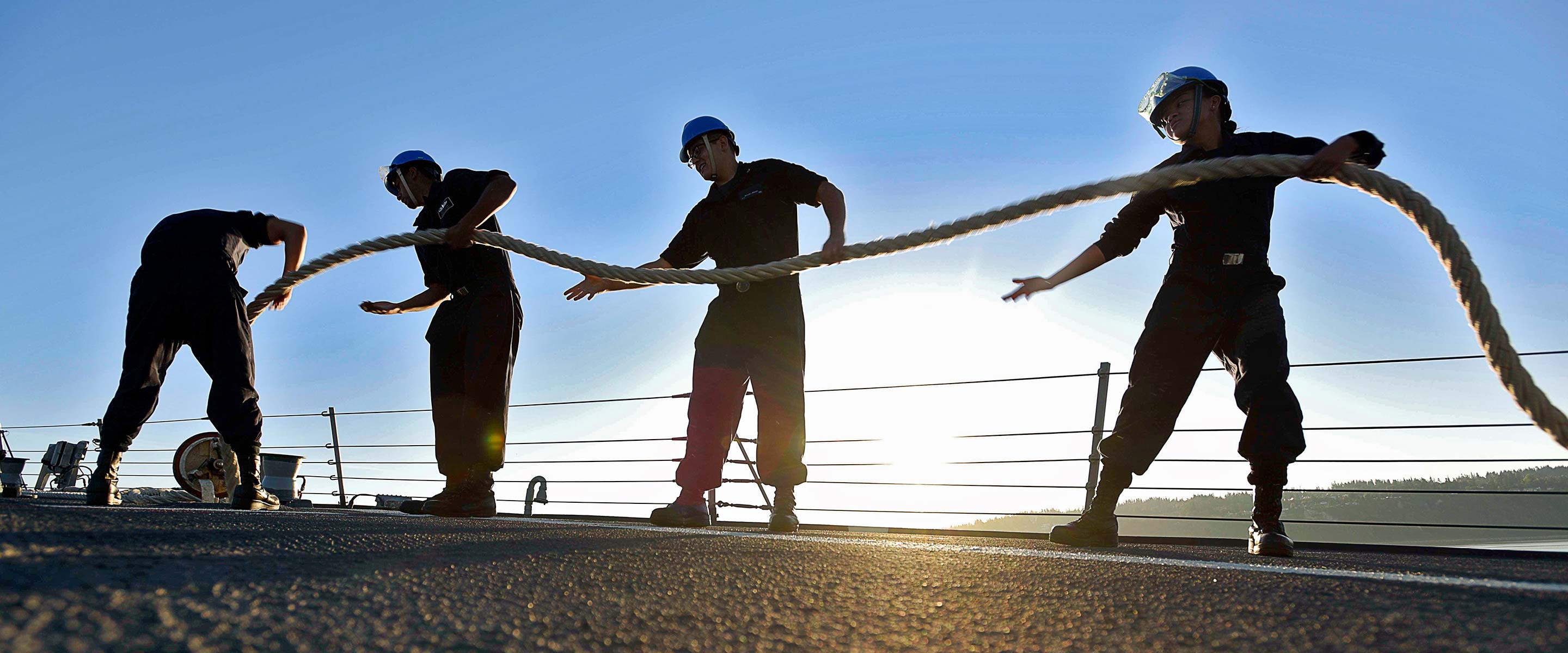 Navy boatswain's mates work with the ropes on a Navy ship