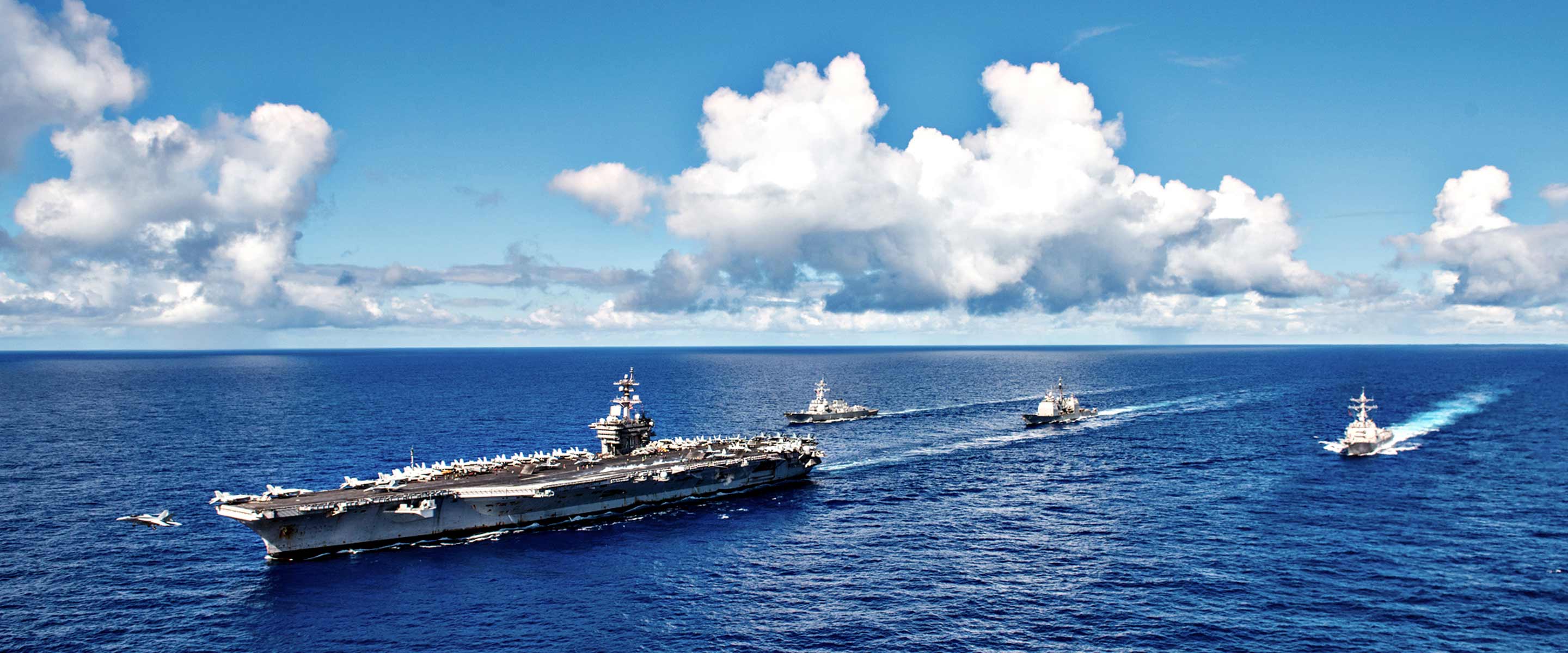 Navy strike group sails toward a mission in the ocean