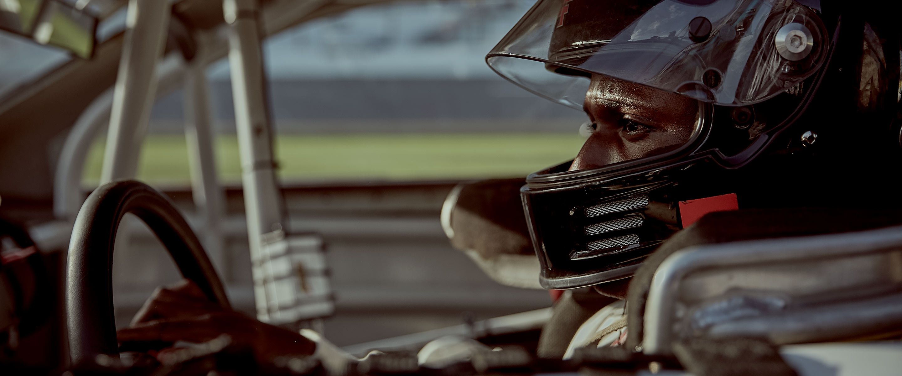 Racecar driver and Navy Surface Warfare  Lieutenant Jesse Iwuji at the wheel