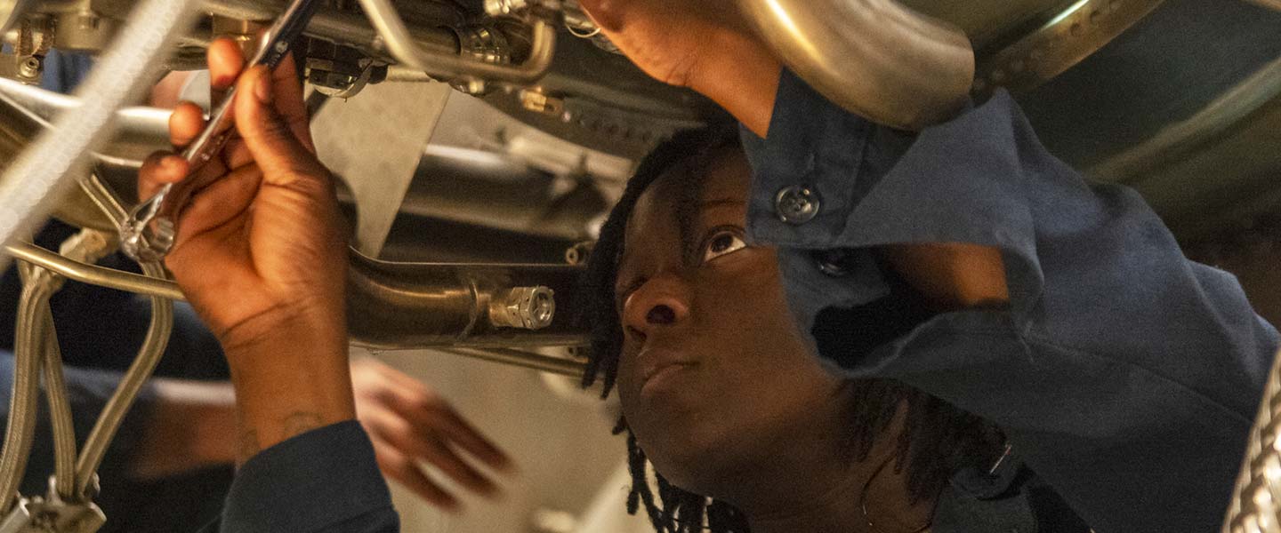 A United States Navy Gas Turbine Systems Technician (Mechanical) reattaches a gas turbine sensor during maintenance aboard the USS Makin Island.