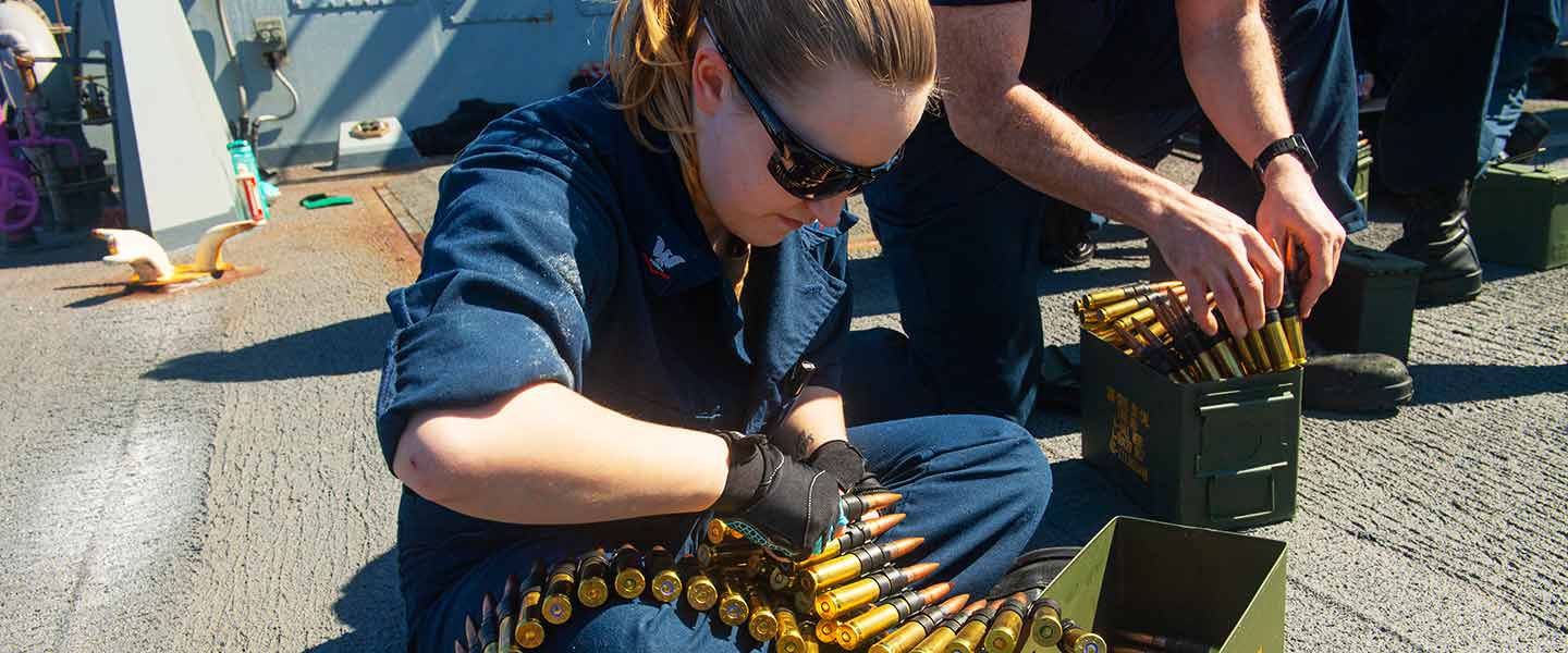A United States Navy Gunner’s Mate prepares .50-caliber ammunition aboard the USS Mahan destroyer.