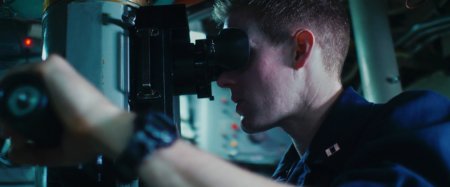 A United States Navy Submarine Officer monitors surface activity aboard a submarine.