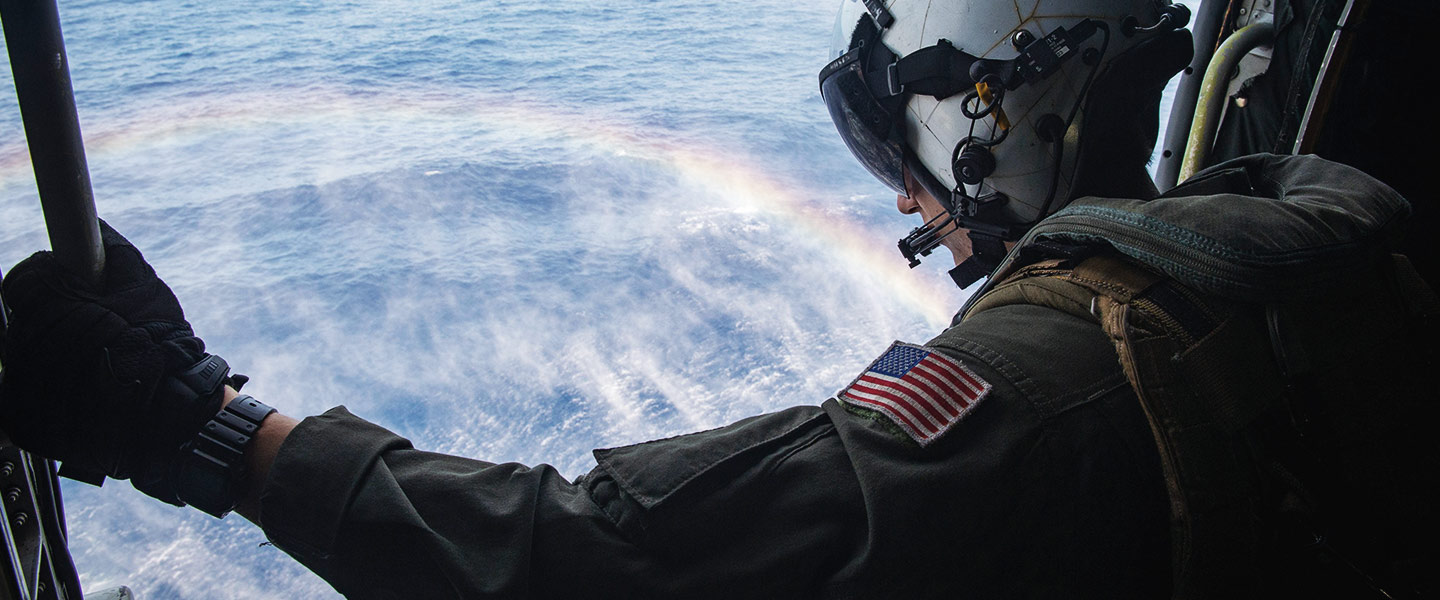 A United States Navy Helicopter Tactical Aircrewman sits in a MH-60R Sea Hawk.