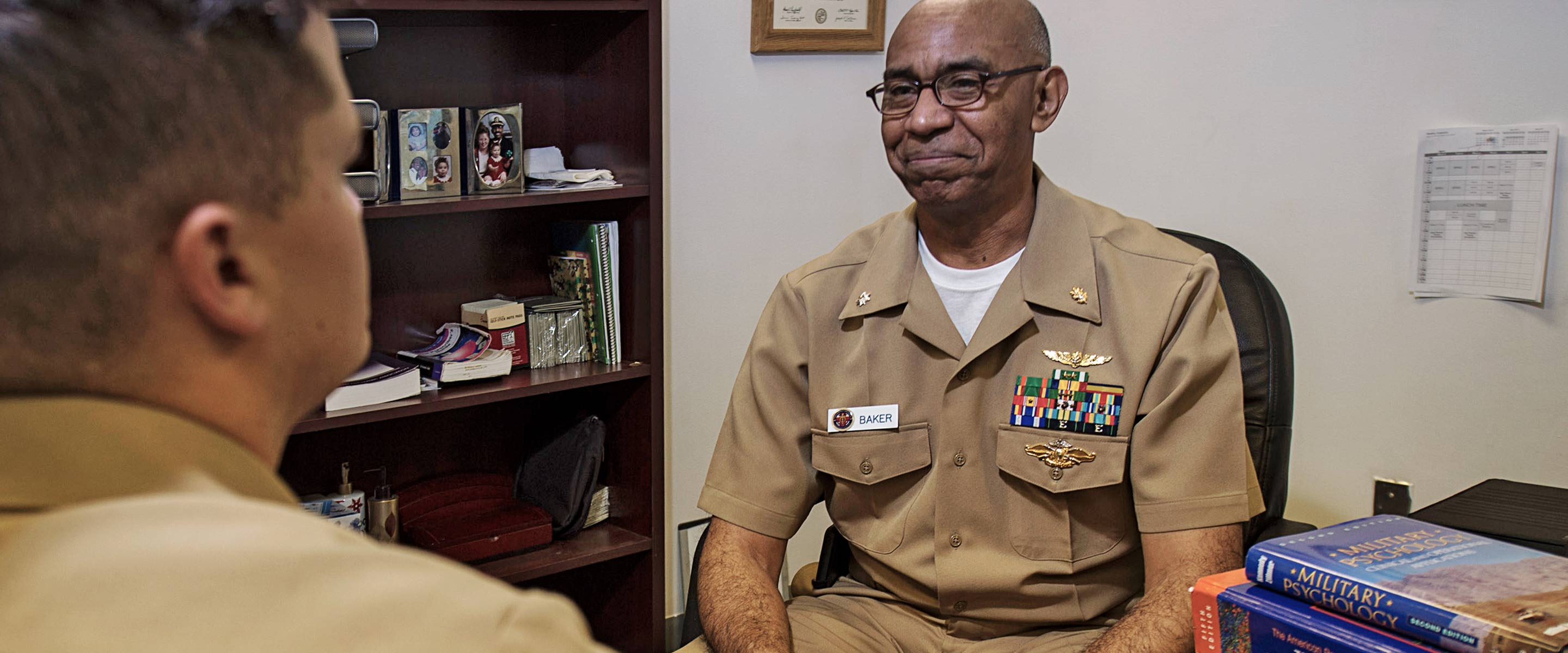 A Navy Clinical Psychologist works with another officer to maintain mental health.