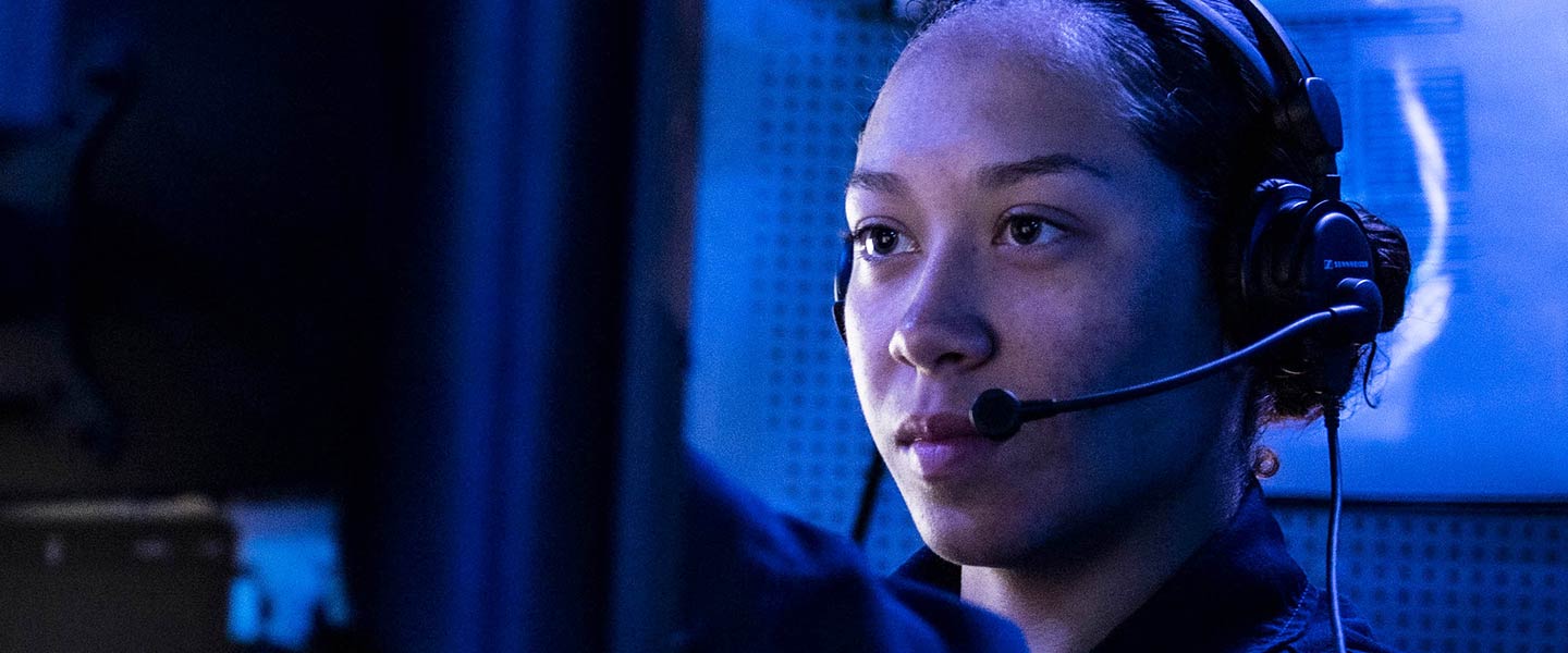 A United States Navy Cryptologic Technician Technical stands watch in the combat information center of the Arleigh Burke-class guided-missile destroyer USS Milius.