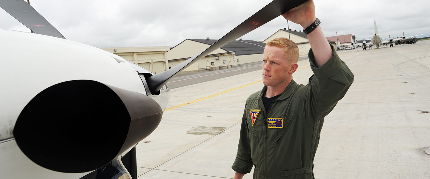 A United States Navy Aircrewman Avionics performs checks before a flight.