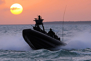 Special Warfare Combat Crewman conduct special reconnaissance in a small boat