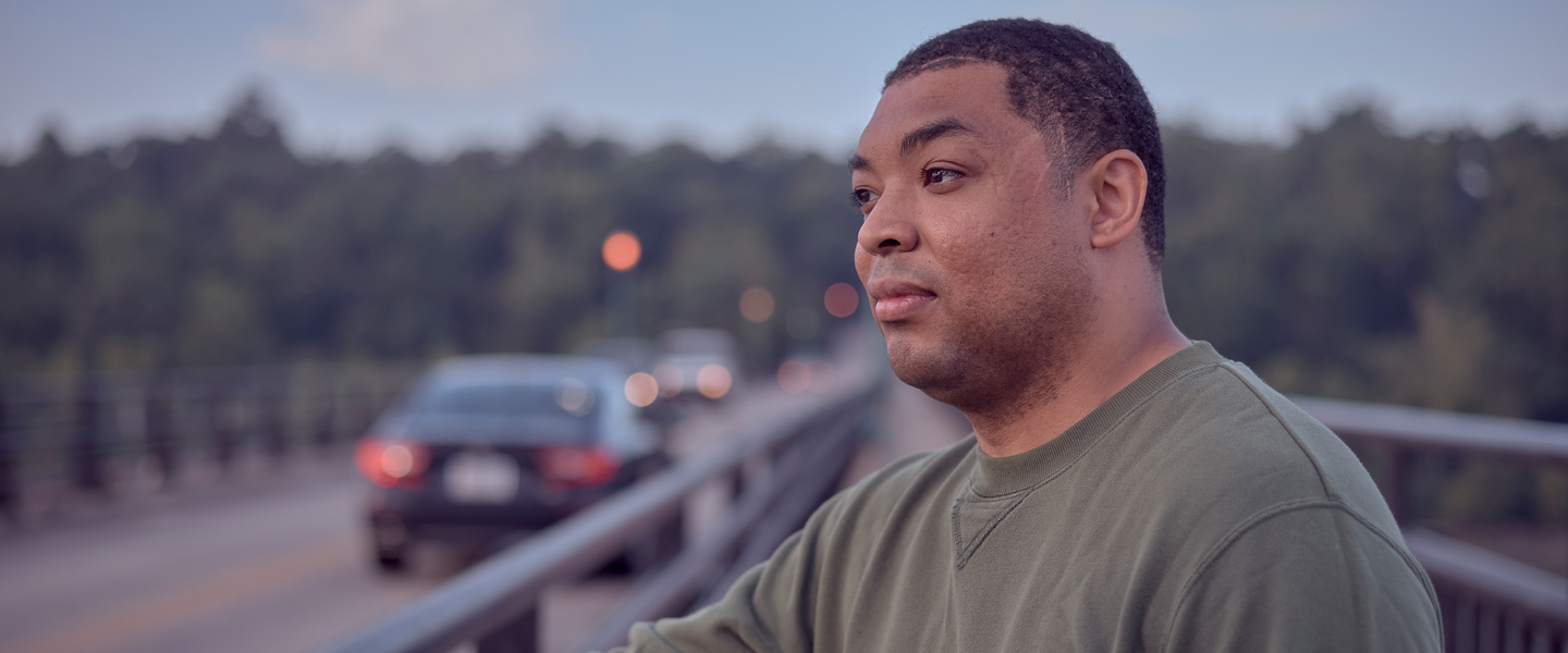 Dominique Velazquez, U.S. Navy hospital corpsman, takes a walk on the bridge where a serious car accident nearly prevented him from becoming a navy sailor