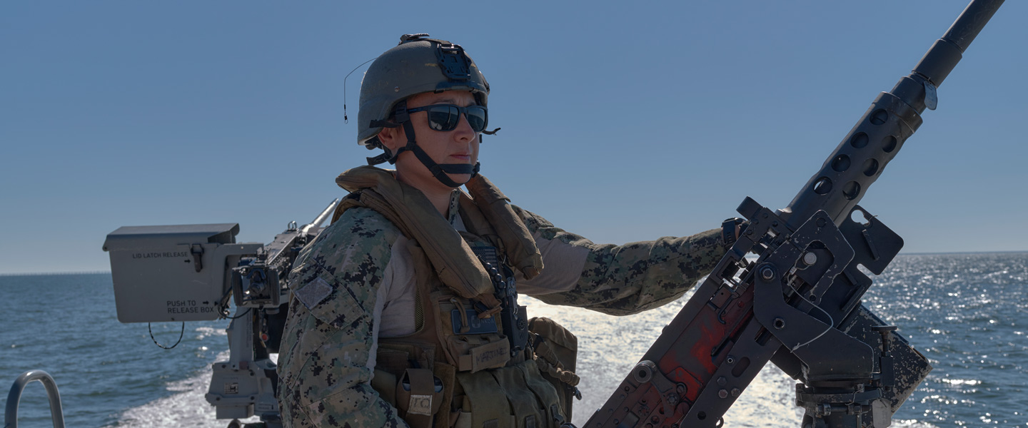 A United States Navy Engineman and Coxswain works aboard a Mark VI Patrol Boat.