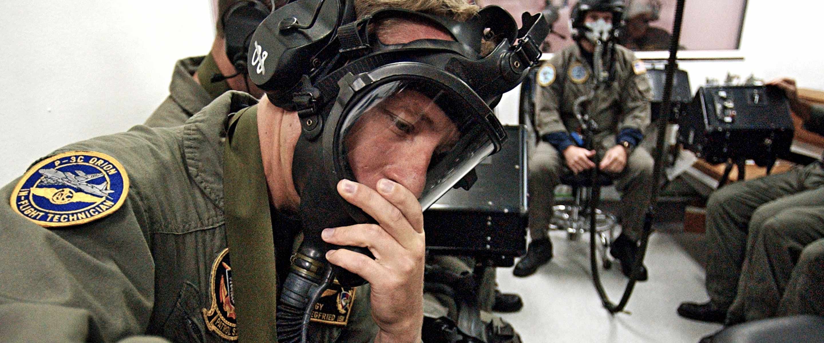 Navy pilot is tested by a team of Aerospace and Operational Physiologists