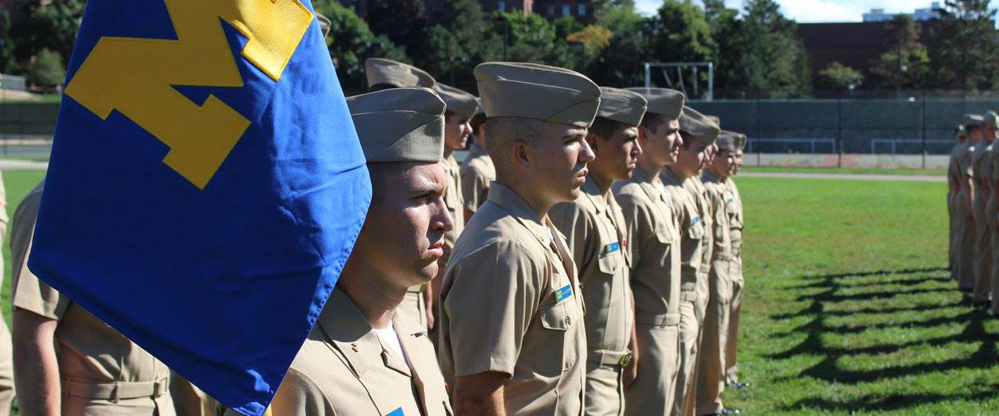 College students training for the United States Navy in ROTC stand in formation