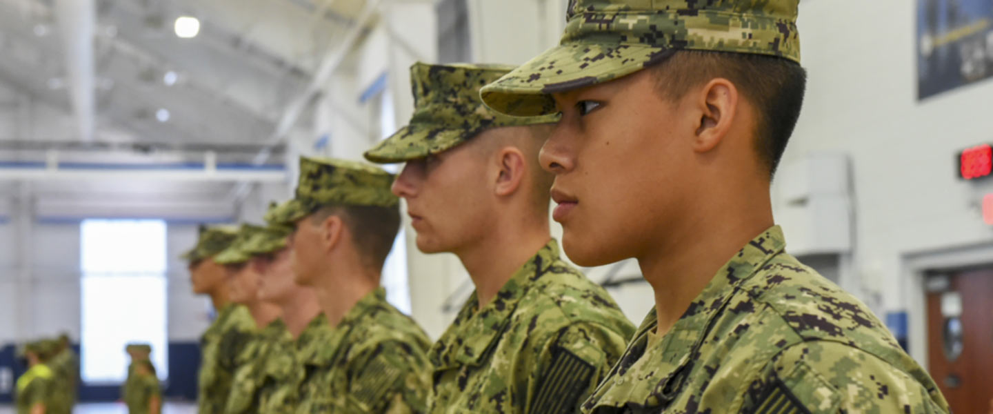 New Student Indoctrination midshipman candidates stand at attention inside Atlantic Fleet Drill Hall at Recruit Training Command (RTC) as part of NSI.