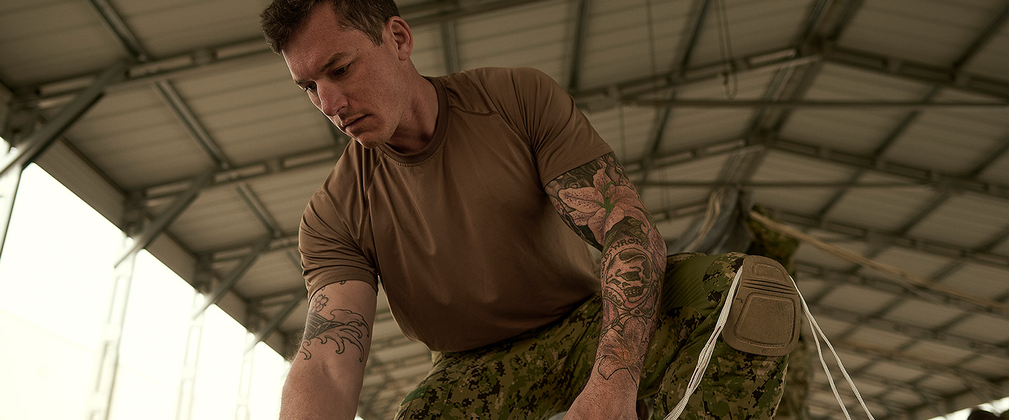 US Navy sailor SB1 Nick O’Sullivan inspects a boat used on water-based Special Warfare Combat Crewman missions