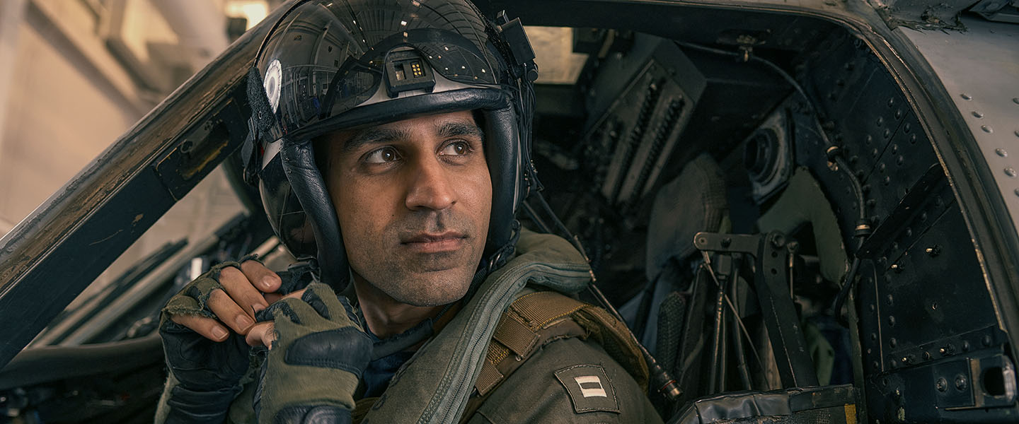 A Navy pilot settles into the cockpit of his jet to get ready for takeoff. 