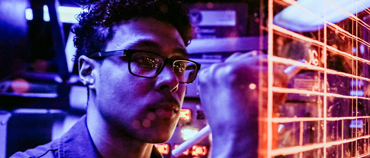 A United States Navy Cryptologic Technician works at a station aboard a ship.