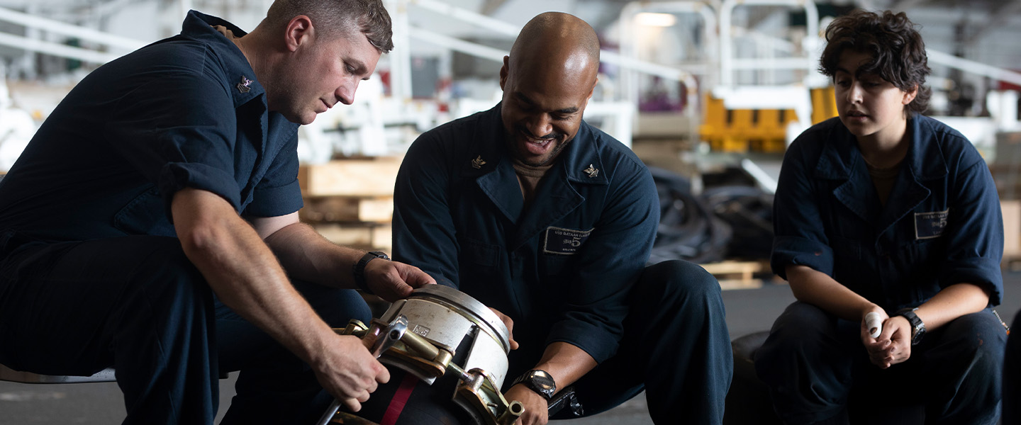 U.S. Navy Sailors performing ship maintenance.