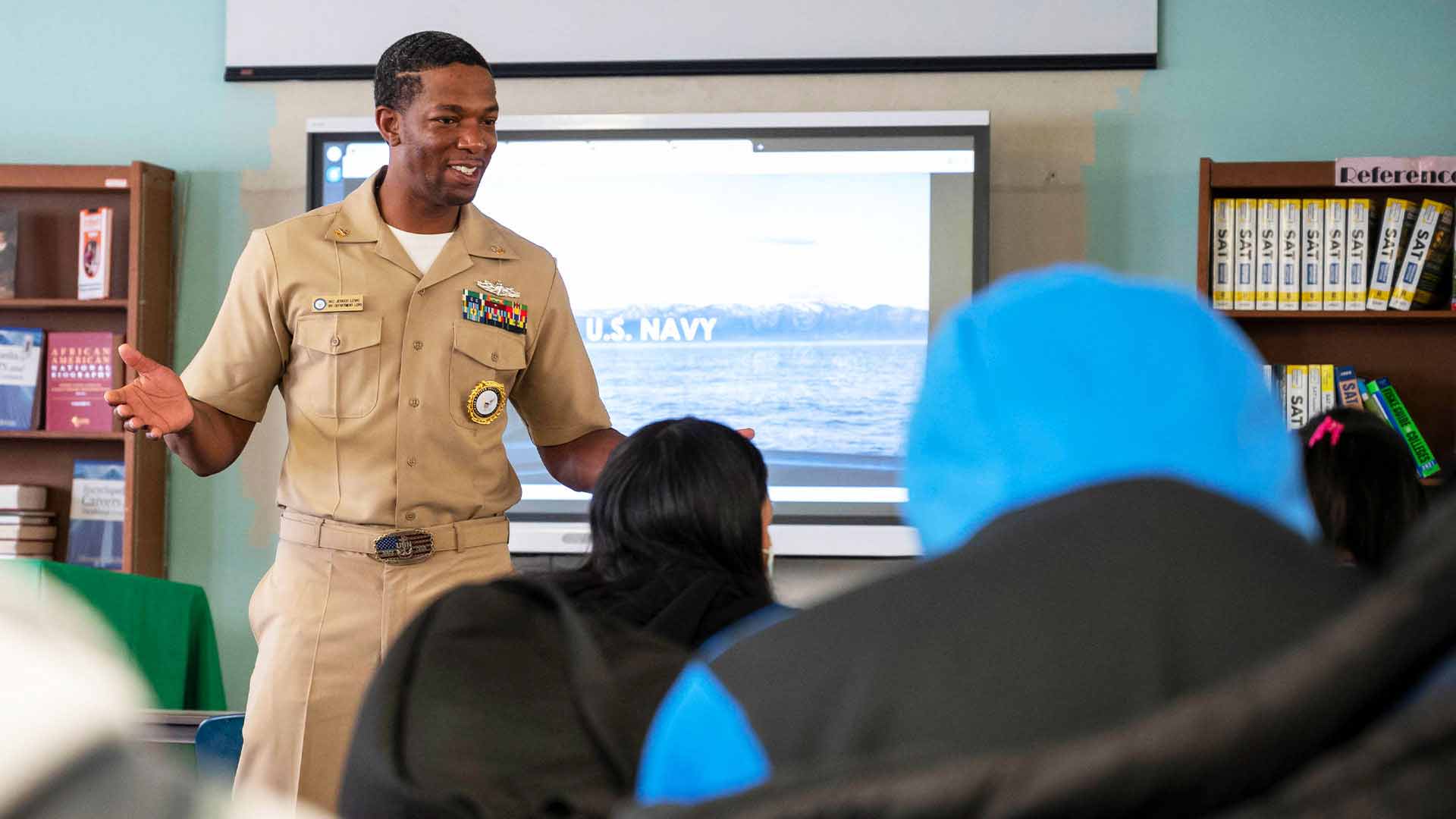 A U.S. Navy recruiter speaks with potential recruits.