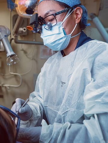 A U.S. Navy Dentist examines a Sailor’s teeth during a routine dental procedure