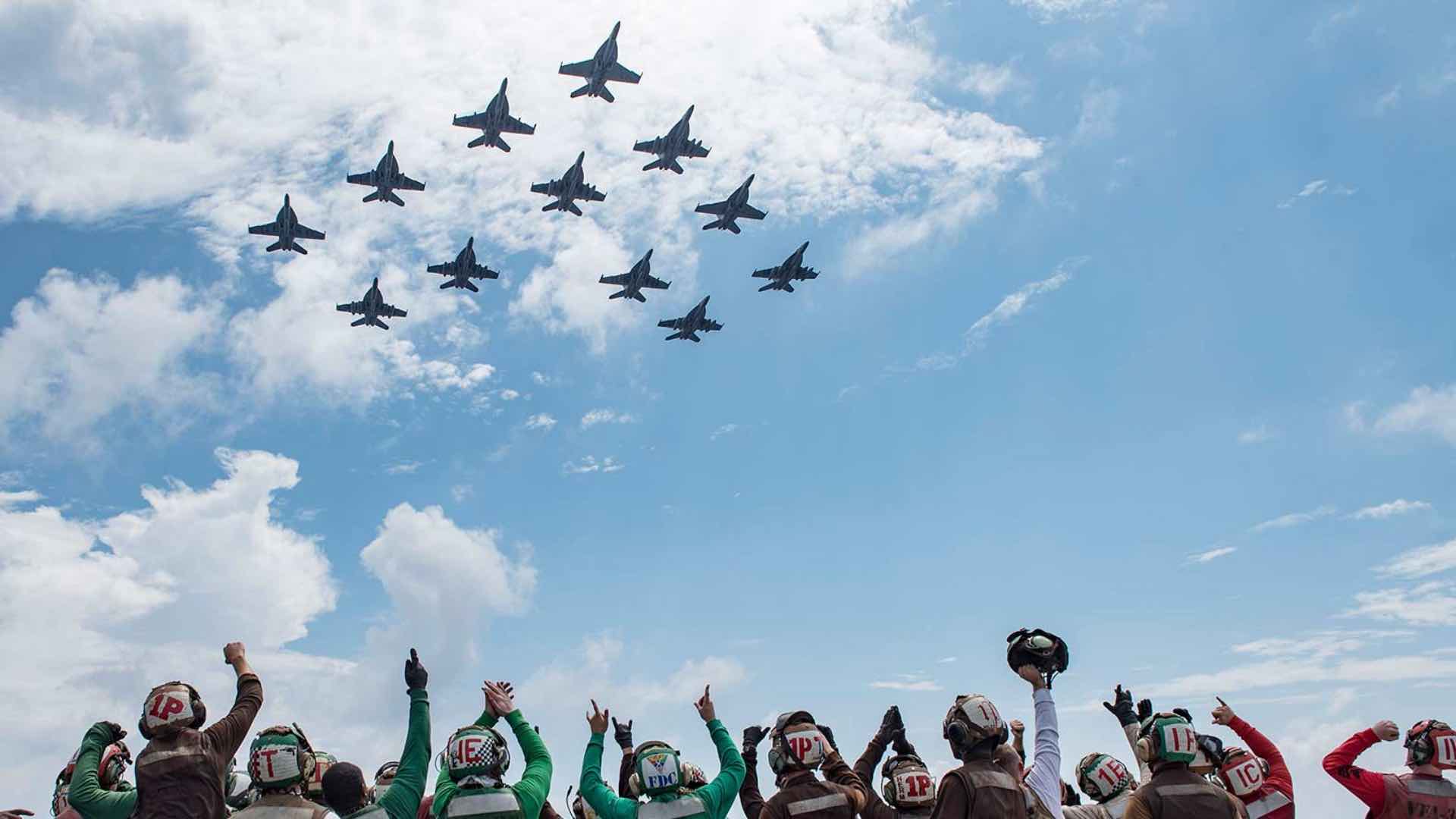Navy Enlistees Celebrating F/A-18 Super Hornets Jets in Formation
