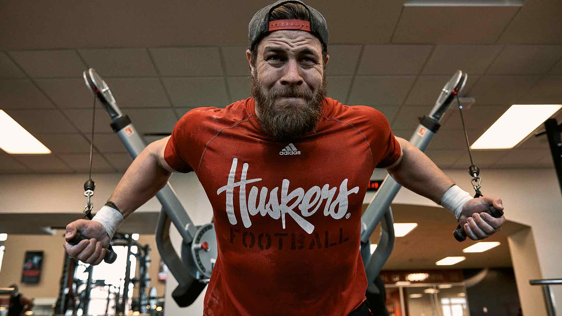 Damian Jackson former U.S. Navy Seal and current football player for the Nebraska Cornhuskers, spends time exercising in the weight room