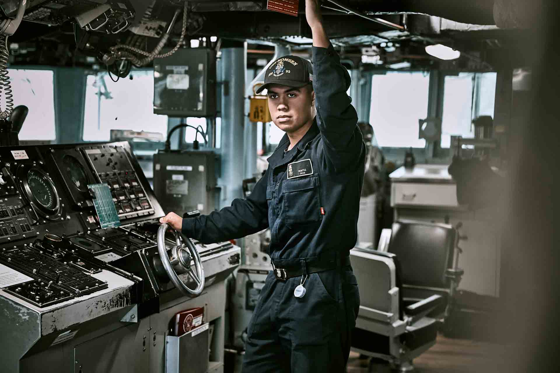U.S. Navy Sailor Michael Benitez operates navigational equipment aboard a Navy ship