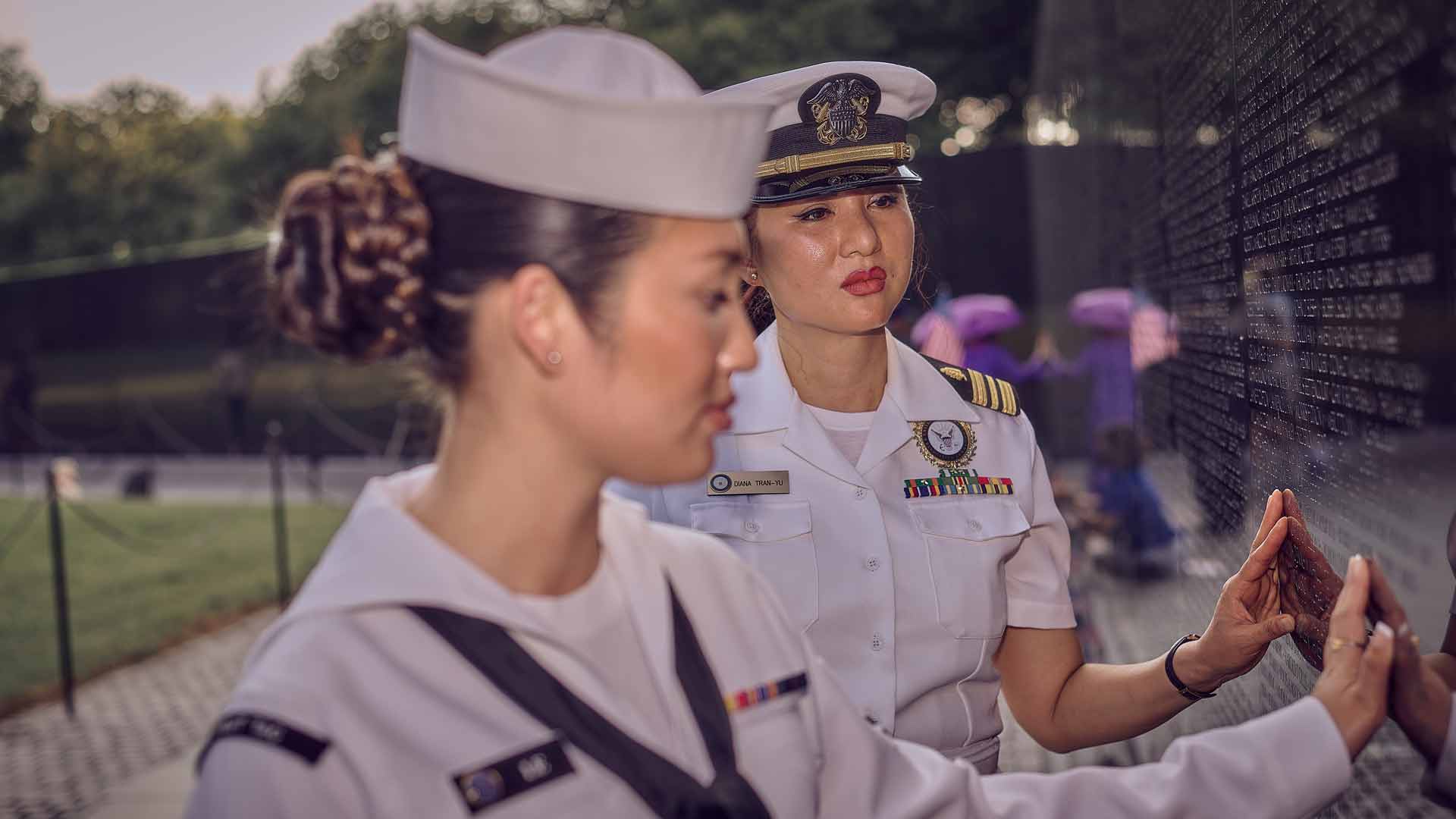 A United States Navy Lieutenant Commander and Health Care Administrator visits the Vietnam War Memorial in Washington, D.C., with her daughter, a Navy Intelligence Specialist.