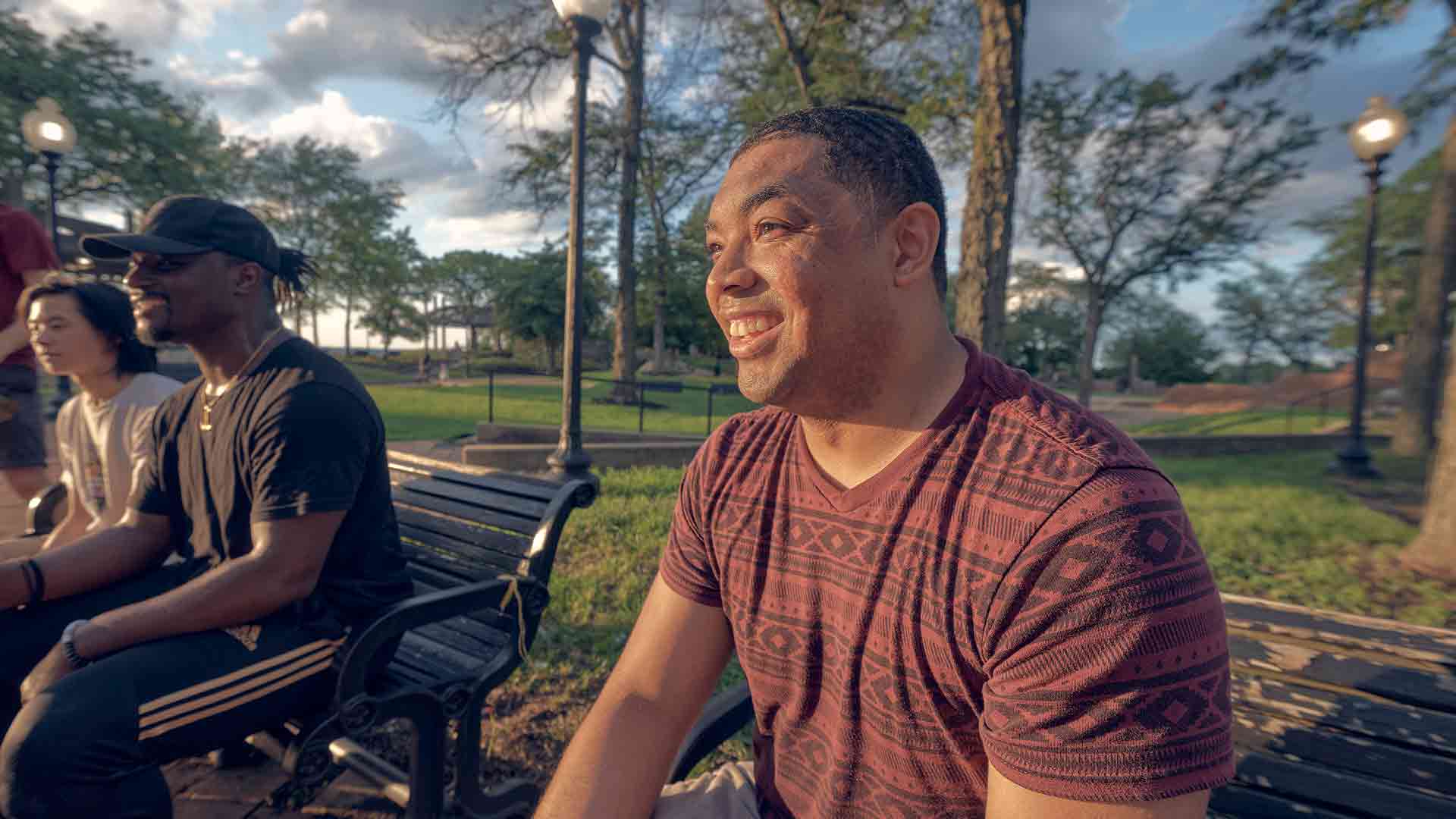 Dominique Velazquez, U.S. Navy Hospital Corpsman, smiles during quality time with friends at a sunlit park