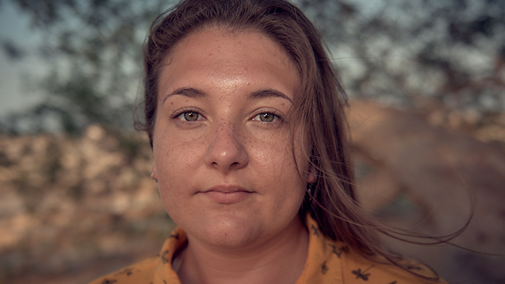 Myah Riggans, navy linguist, poses for a photo at the Tree of Life in Bahrain