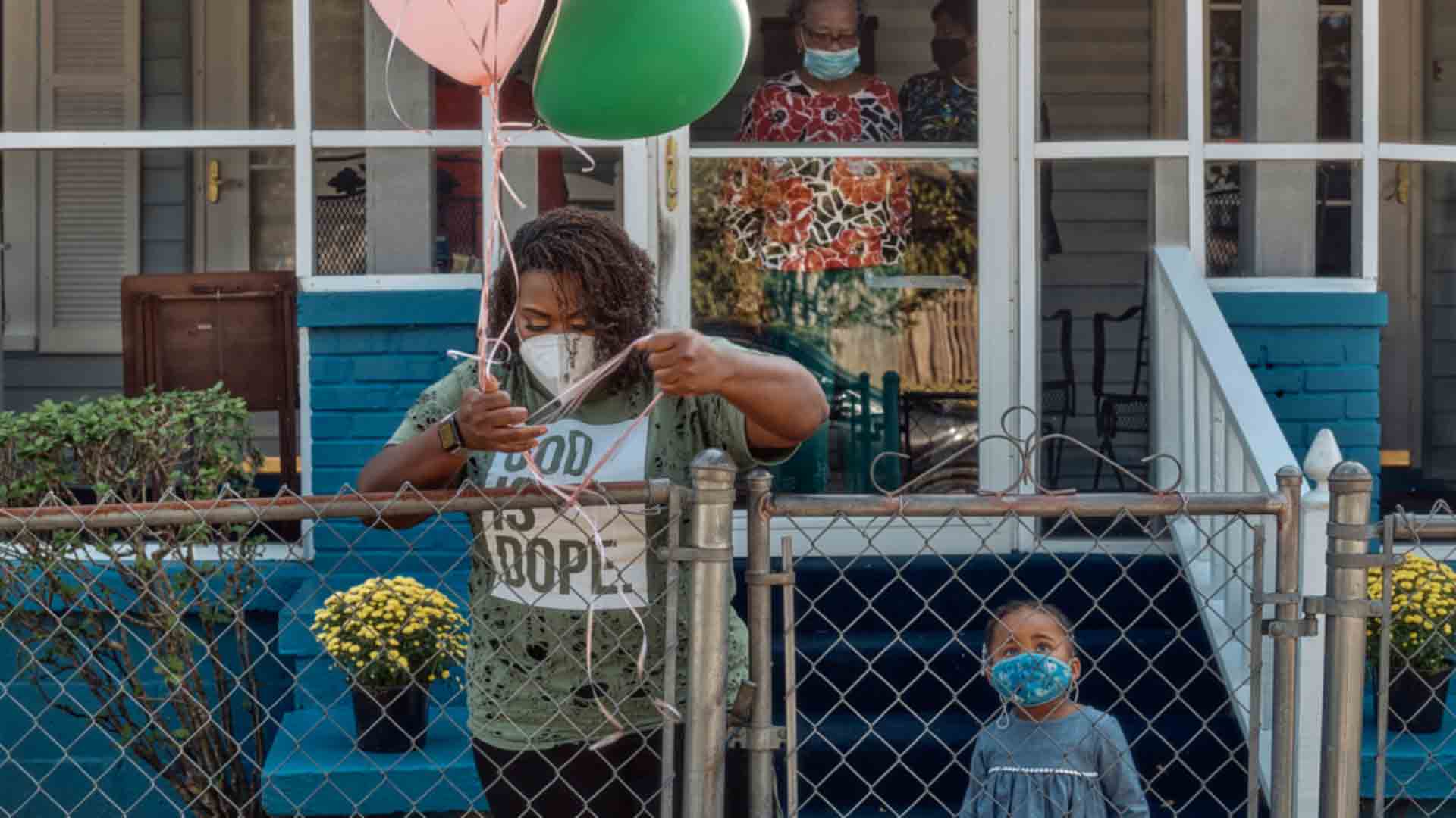 Navy chaplain Autumn Wilson spends time with her family at home and places balloons along their fence for an upcoming celebration. 