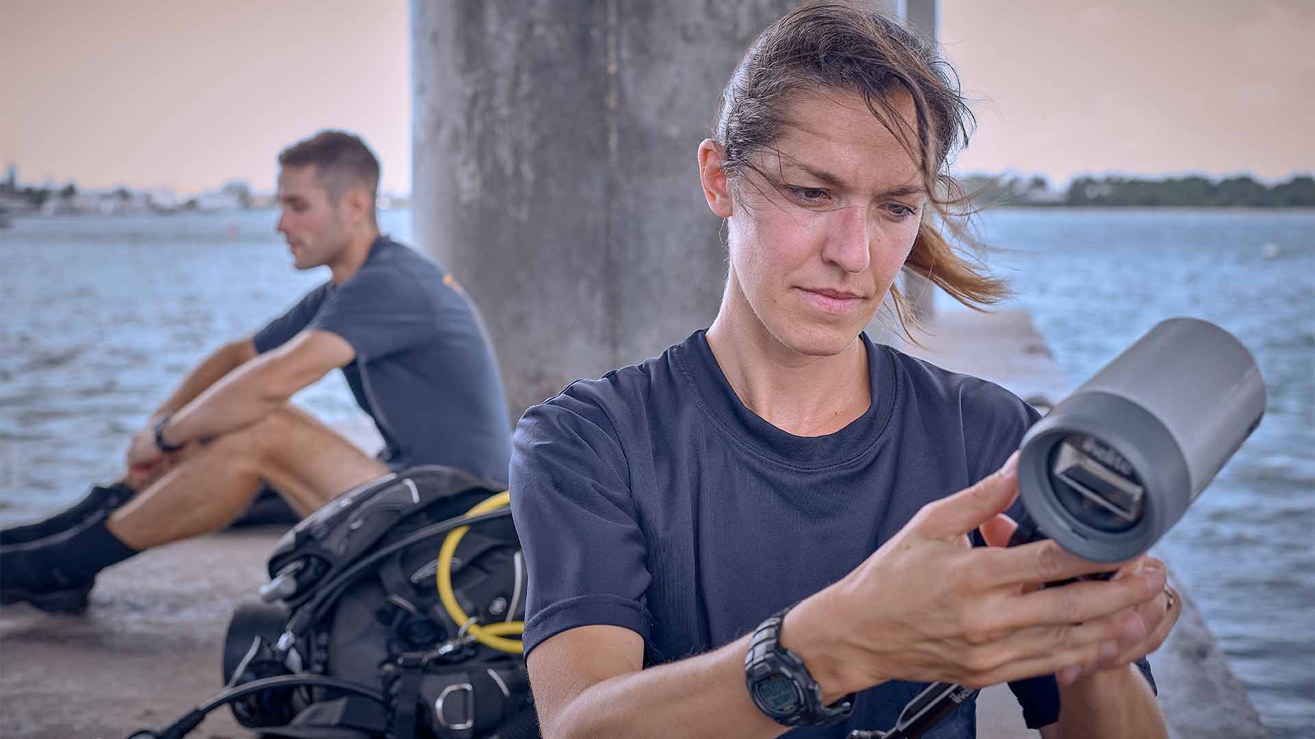 Navy photographer and mass communications specialist Kathleen Gorby adjusts her camera equipment in preparation for an underwater photo shoot. 