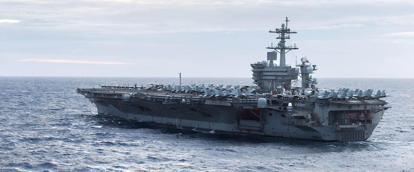 The USS Theodore Roosevelt aircraft carrier (CVN 71) sails through the open ocean.